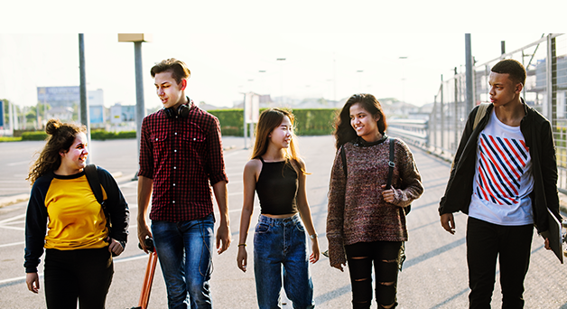 Five young people walking together