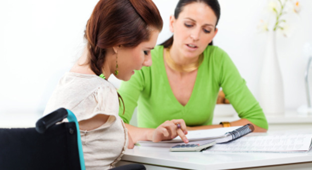 Image of a young person with a disability and a teacher