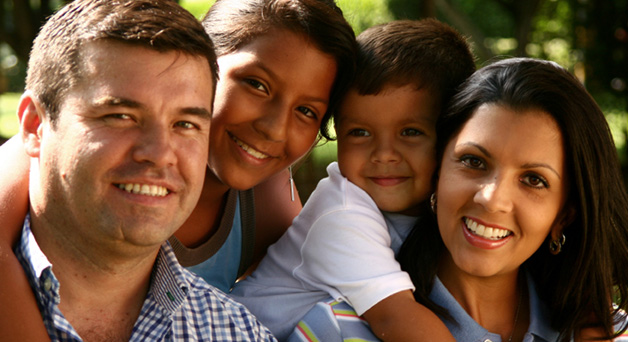 Image of a family of four looking directly at the camera