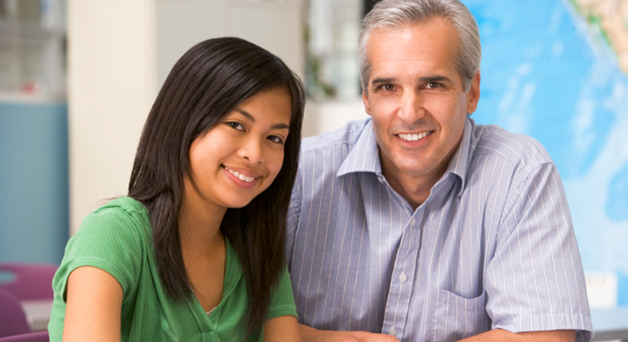 Image of a man and a teenage girl looking at the camera