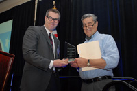 Jack Calhoun, Senior Consultant to the Forum (right) receives an award from Thomas Abt, U.S. Department of Justice