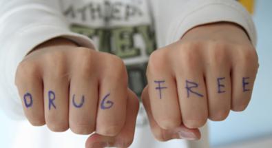 Youth with the words DRUG FREE written on knuckles